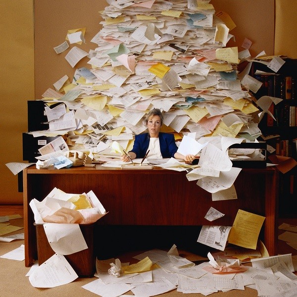 There is a terrible mess in the office papers. Can you file them into the appropriate drawers? 